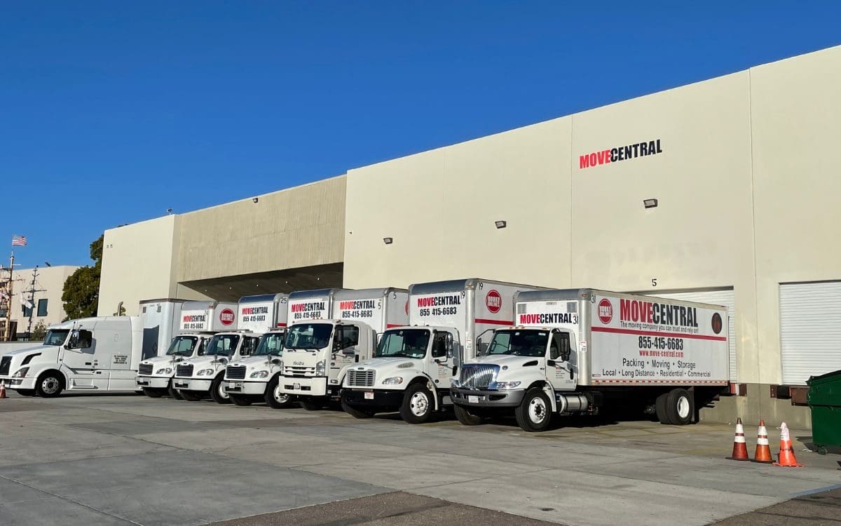 Move Central branded moving trucks parked outside a warehouse