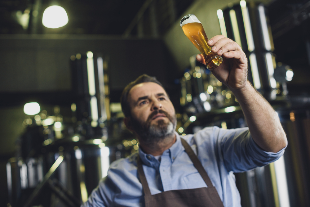 brewer evaluating a glass of beer