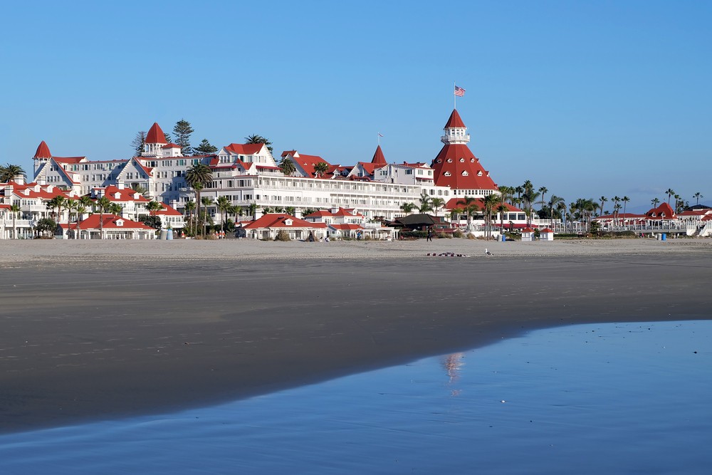 The Hotel Del Coronado, viewed from the shoreline on a sunny day.