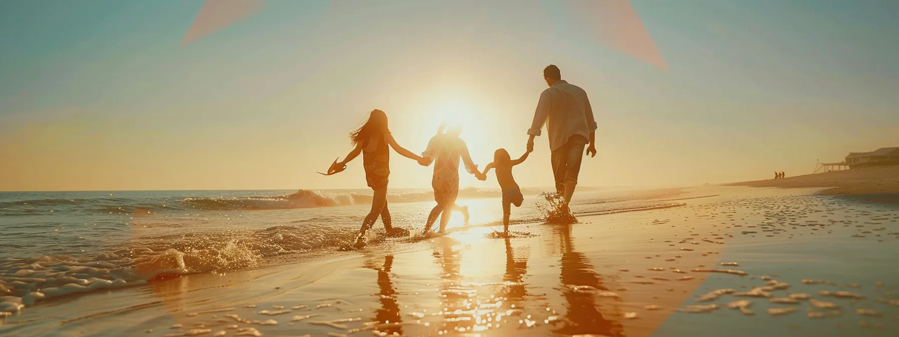 a joyful family playing together on a sun-drenched beach in san diego.